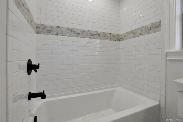 a bathroom with a toilet a sink and a window