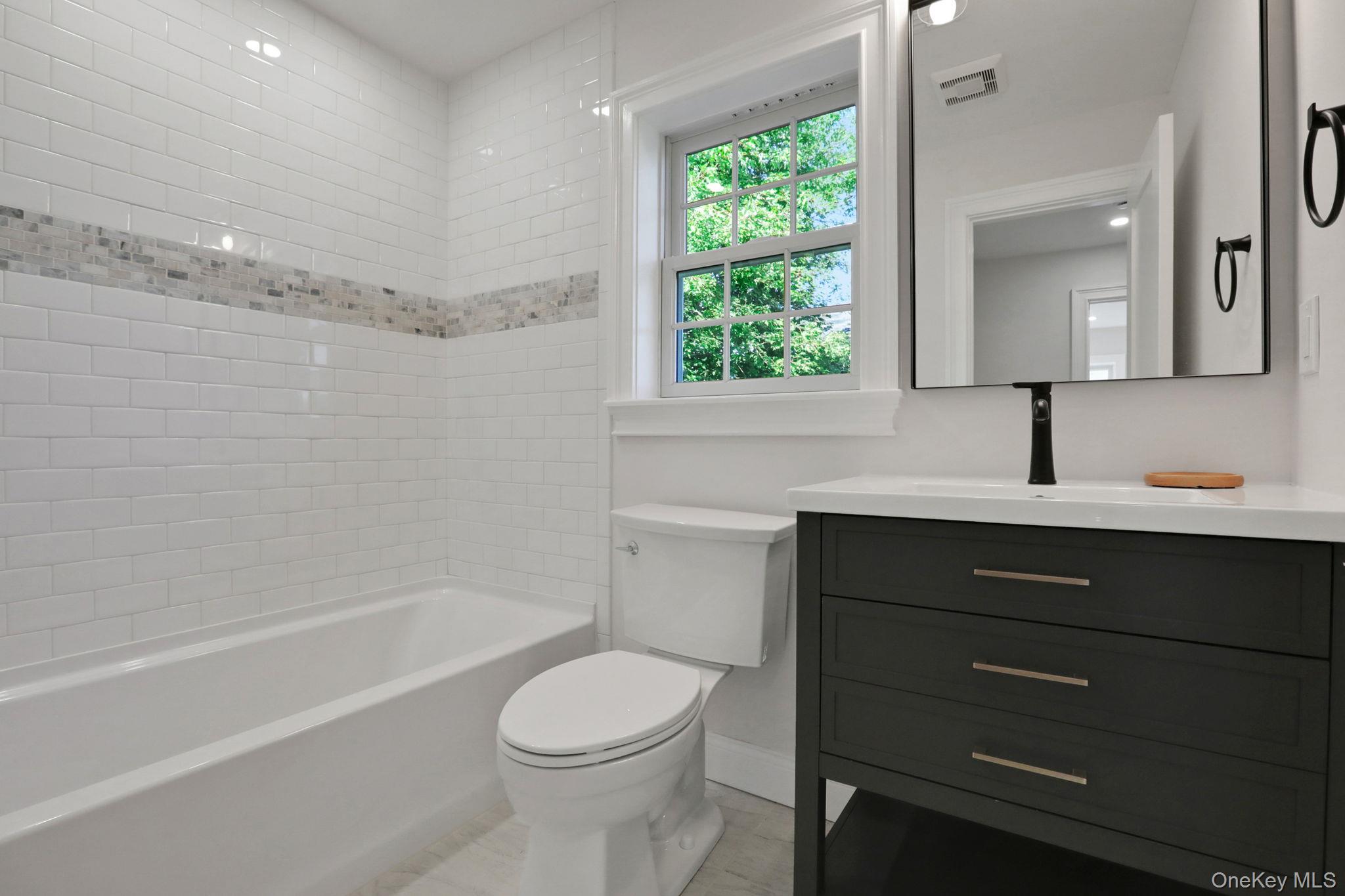 32 Ackerman Street Beacon, NY 12508 - Photo 21 of 37 a bathroom with a sink a toilet and shower