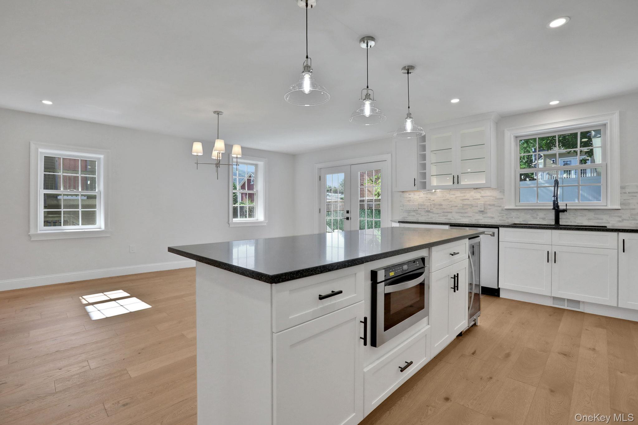 32 Ackerman Street Beacon, NY 12508 - Photo 3 of 37 a kitchen with stainless steel appliances granite countertop a sink a stove a refrigerator and island