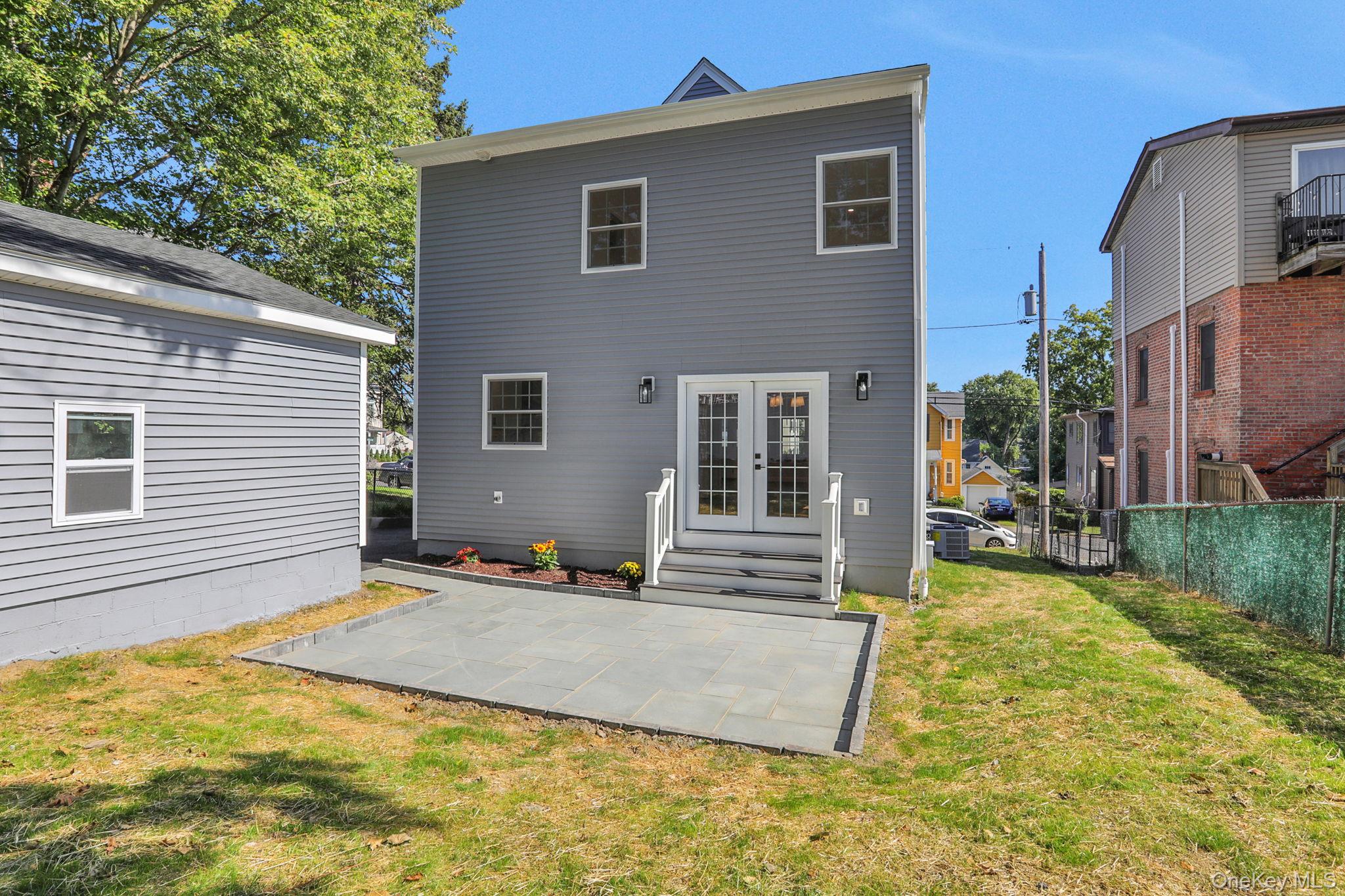 32 Ackerman Street Beacon, NY 12508 - Photo 30 of 37 a view of house with backyard and trees in the background