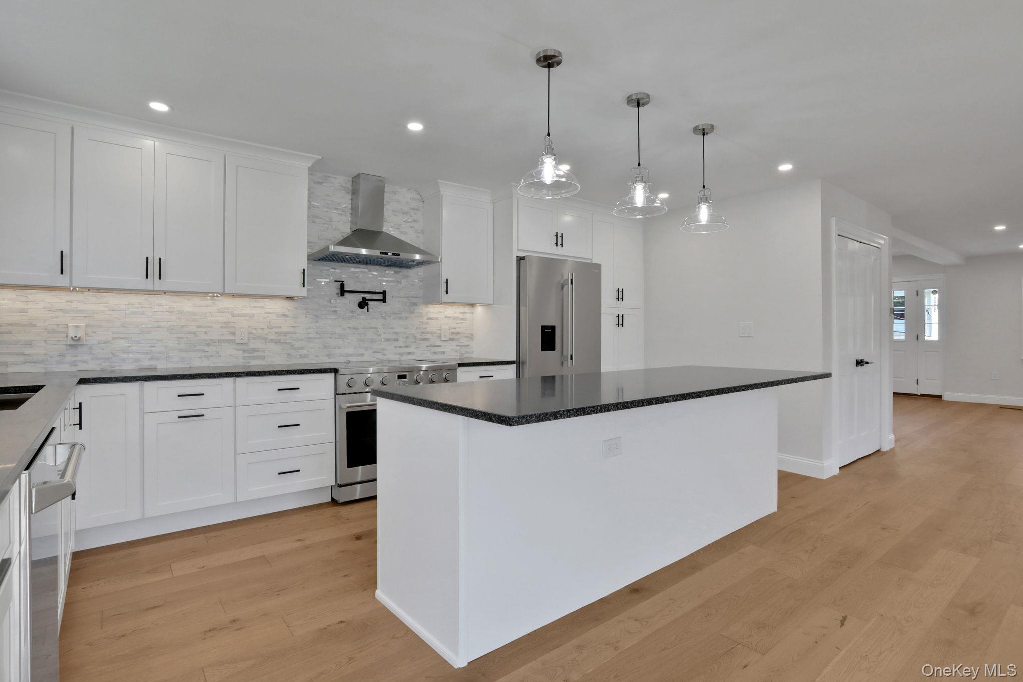 32 Ackerman Street Beacon, NY 12508 - Photo 6 of 37 a kitchen with kitchen island a counter top space appliances and cabinets