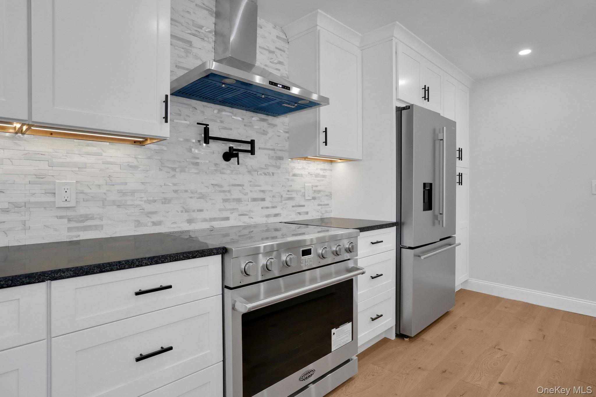 32 Ackerman Street Beacon, NY 12508 - Photo 7 of 37 a kitchen with stainless steel appliances white cabinets and a stove