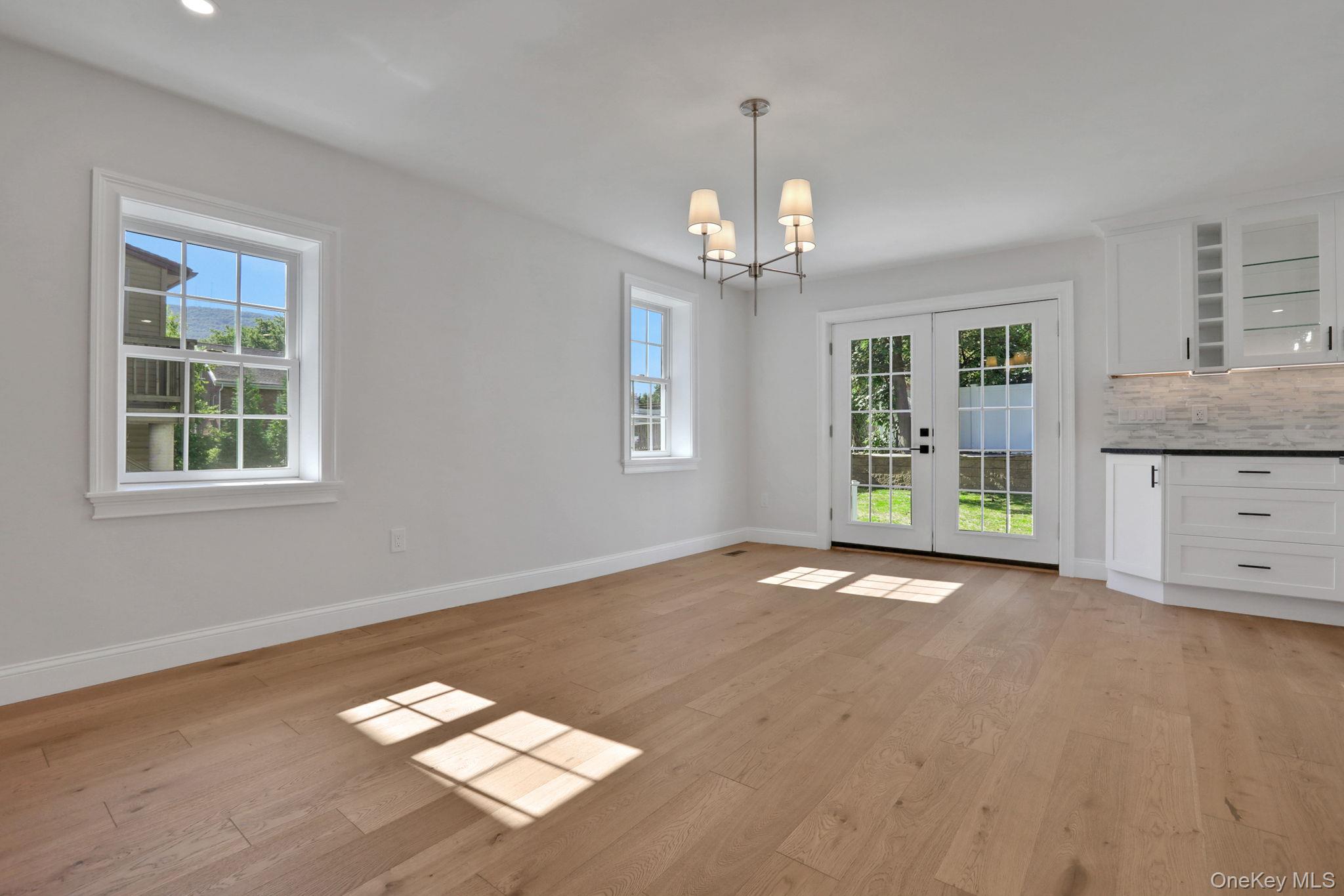 32 Ackerman Street Beacon, NY 12508 - Photo 9 of 37 a view of an empty room with a window and wooden floor