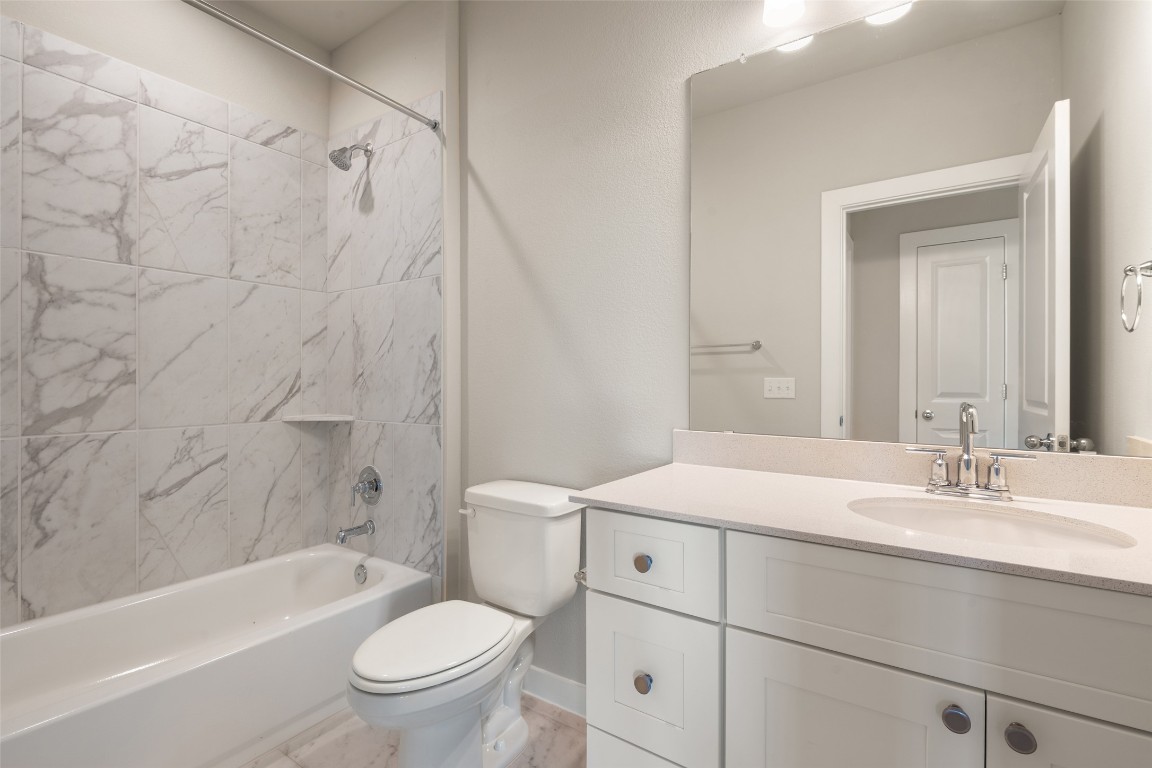 17408 Monastrell Lane Pflugerville, TX 78664 - Photo 12 of 31 a bathroom with a sink a toilet and a bathtub