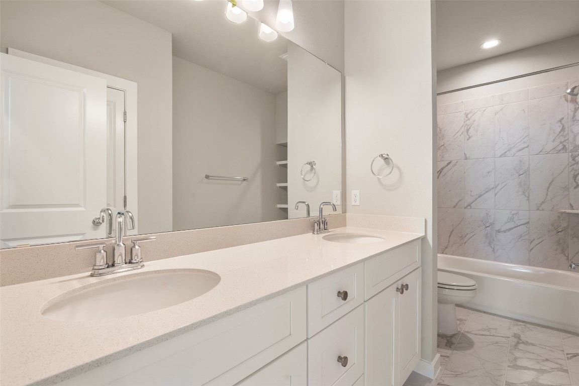 17408 Monastrell Lane Pflugerville, TX 78664 - Photo 17 of 31 a bathroom with a sink double vanity granite tub and a mirror