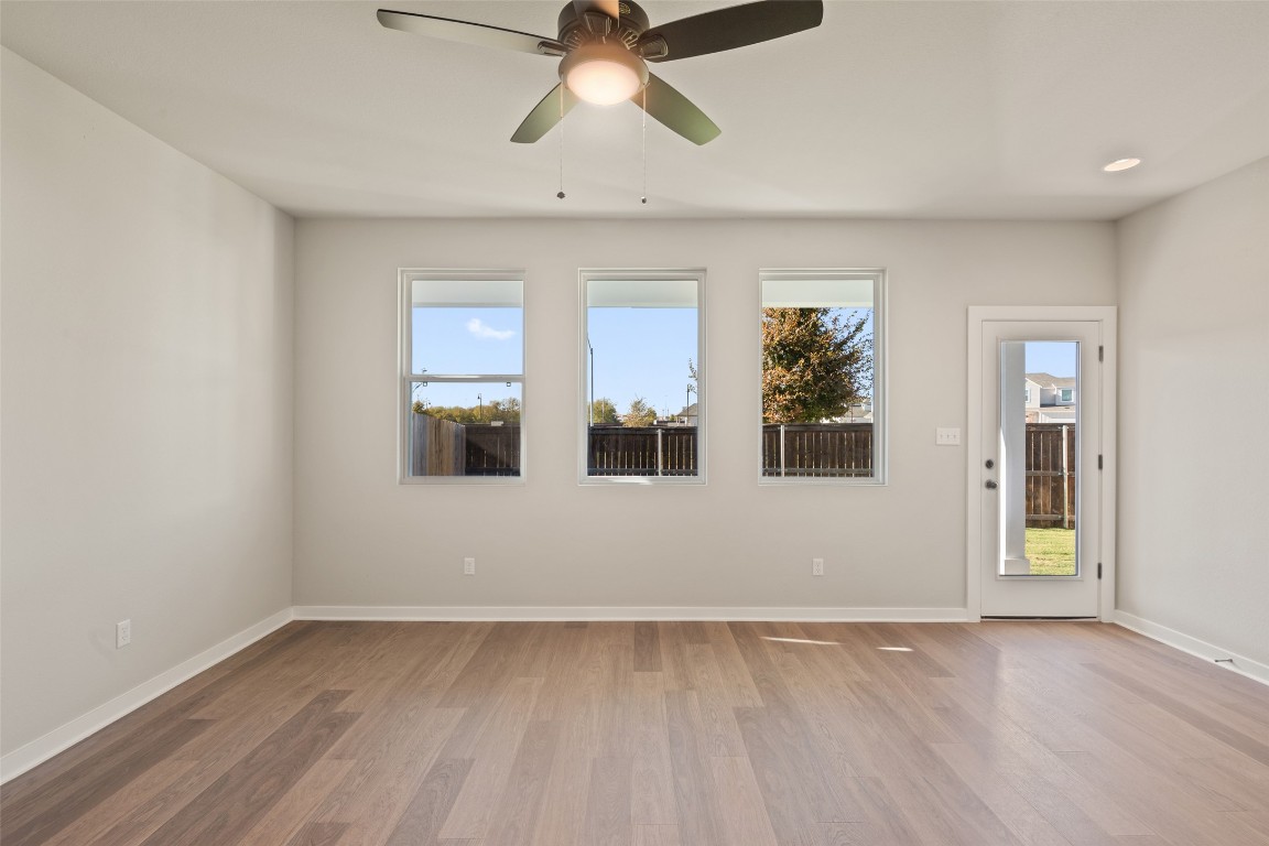 17408 Monastrell Lane Pflugerville, TX 78664 - Photo 8 of 31 a view of empty room with wooden floor and fan