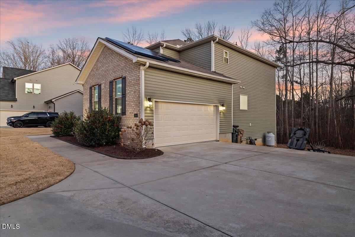 7804 Charters End Street Willow Spring, NC 27592 - Photo 4 of 43 a front view of a house with garden