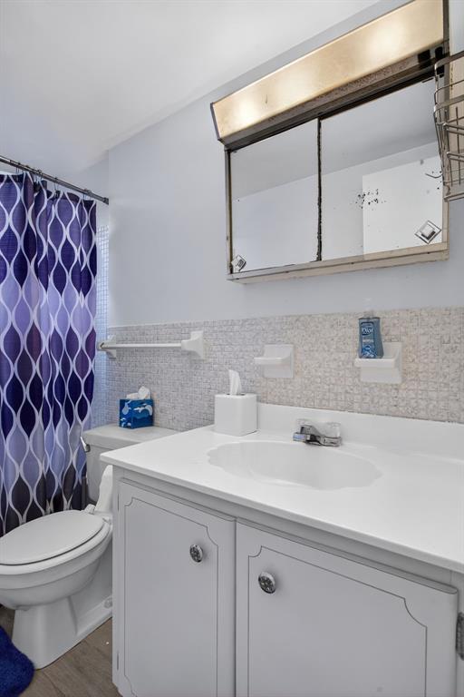 418 South Cypress Road, Unit 110 Pompano Beach, FL 33060 - Photo 15 of 27 a bathroom with a sink a toilet and mirror