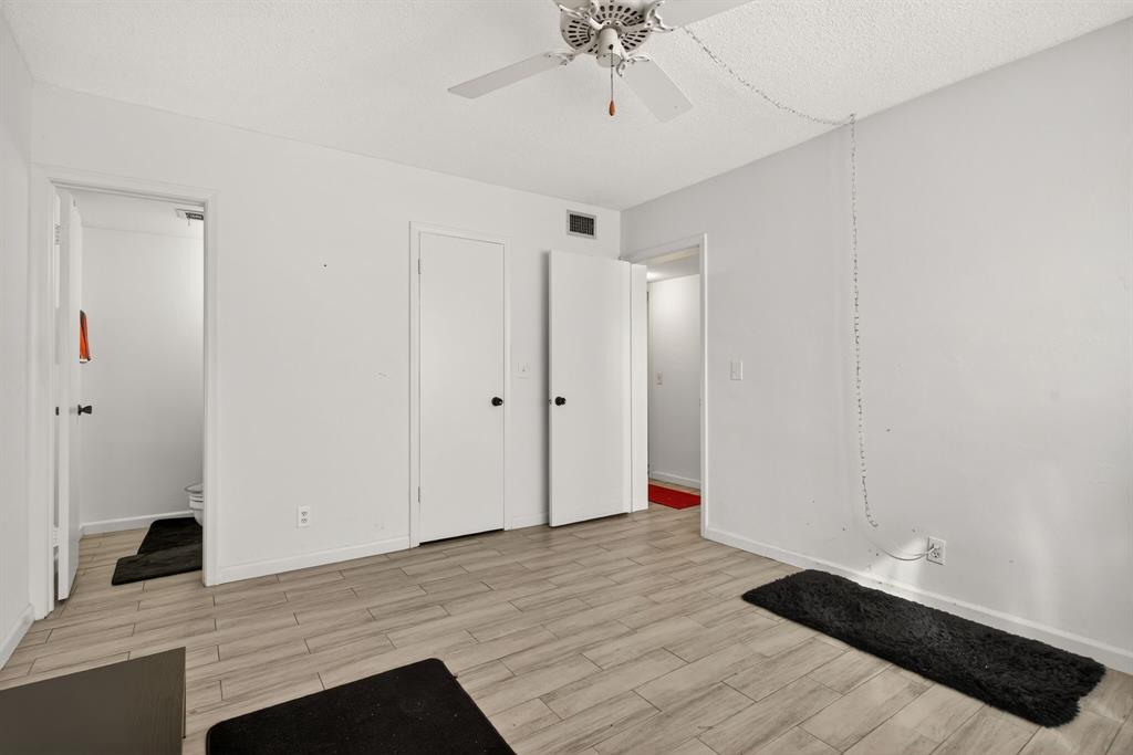 418 South Cypress Road, Unit 110 Pompano Beach, FL 33060 - Photo 17 of 27 a view of entryway with wooden floor and ceiling fan
