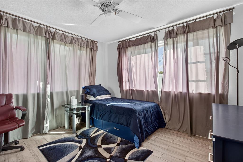 418 South Cypress Road, Unit 110 Pompano Beach, FL 33060 - Photo 21 of 27 a bedroom with bed and a chair