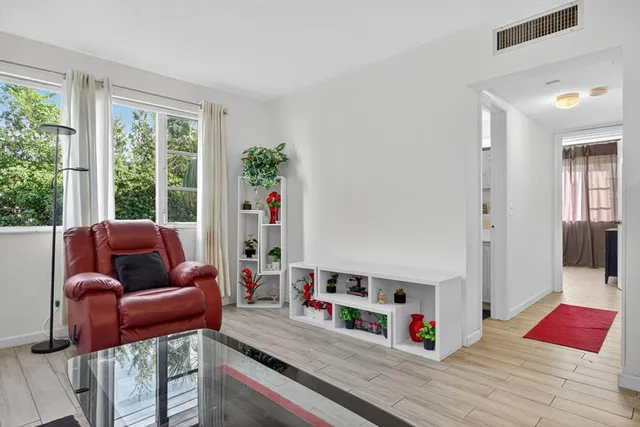 a living room with furniture and a book shelf
