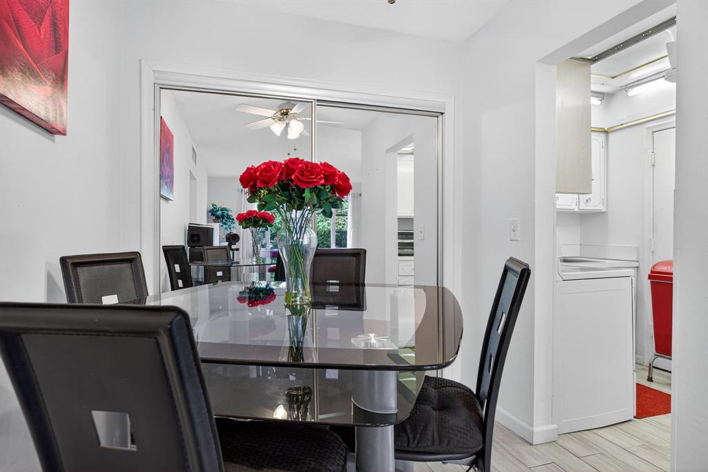 418 South Cypress Road, Unit 110 Pompano Beach, FL 33060 - Photo 7 of 27 a view of a dining room with furniture and a potted plant