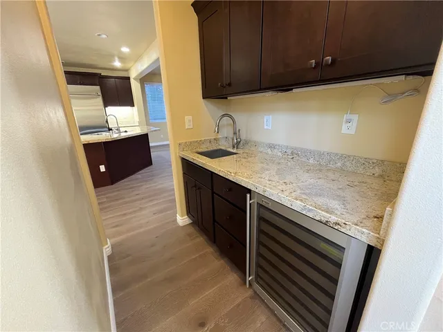 a kitchen with stainless steel appliances granite countertop a sink and a stove