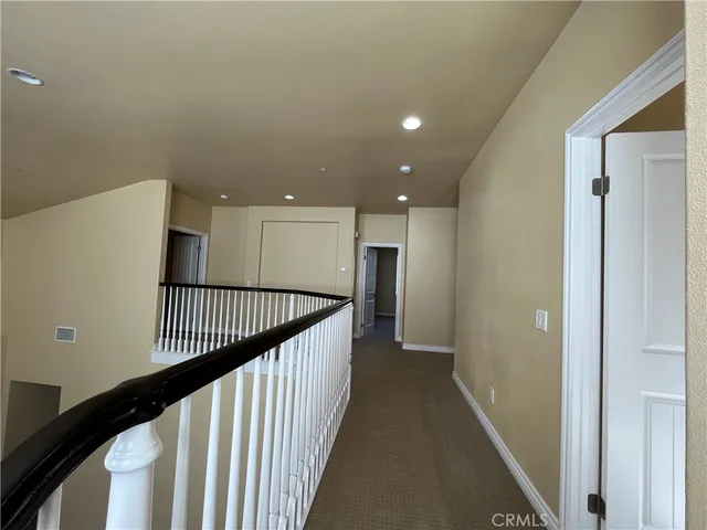 a view of a hallway with stairs