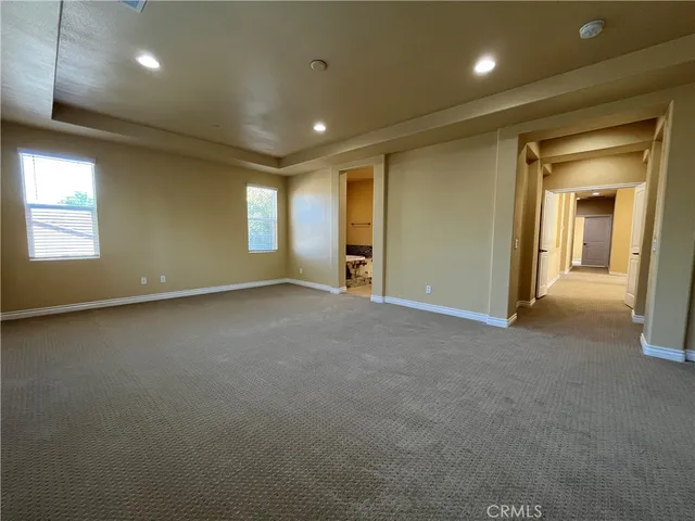 an empty room with a empty space and windows