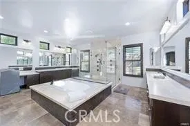 a living room with furniture a flat screen tv and a large window