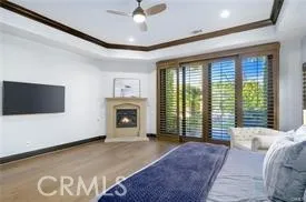 a spacious bedroom with a balcony a bed and a television