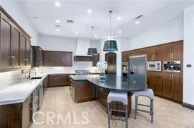 a large kitchen with a table and chairs