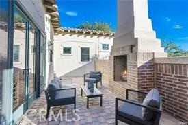 a view of a patio with couches table and chairs and potted plants