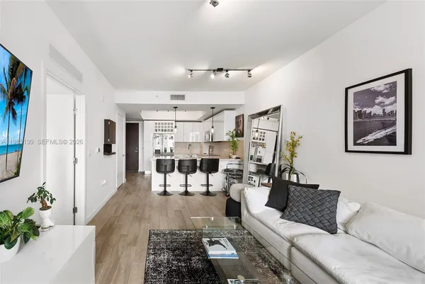 a living room with furniture and wooden floor