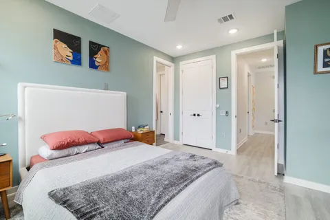 a bedroom with a bed and a couch
