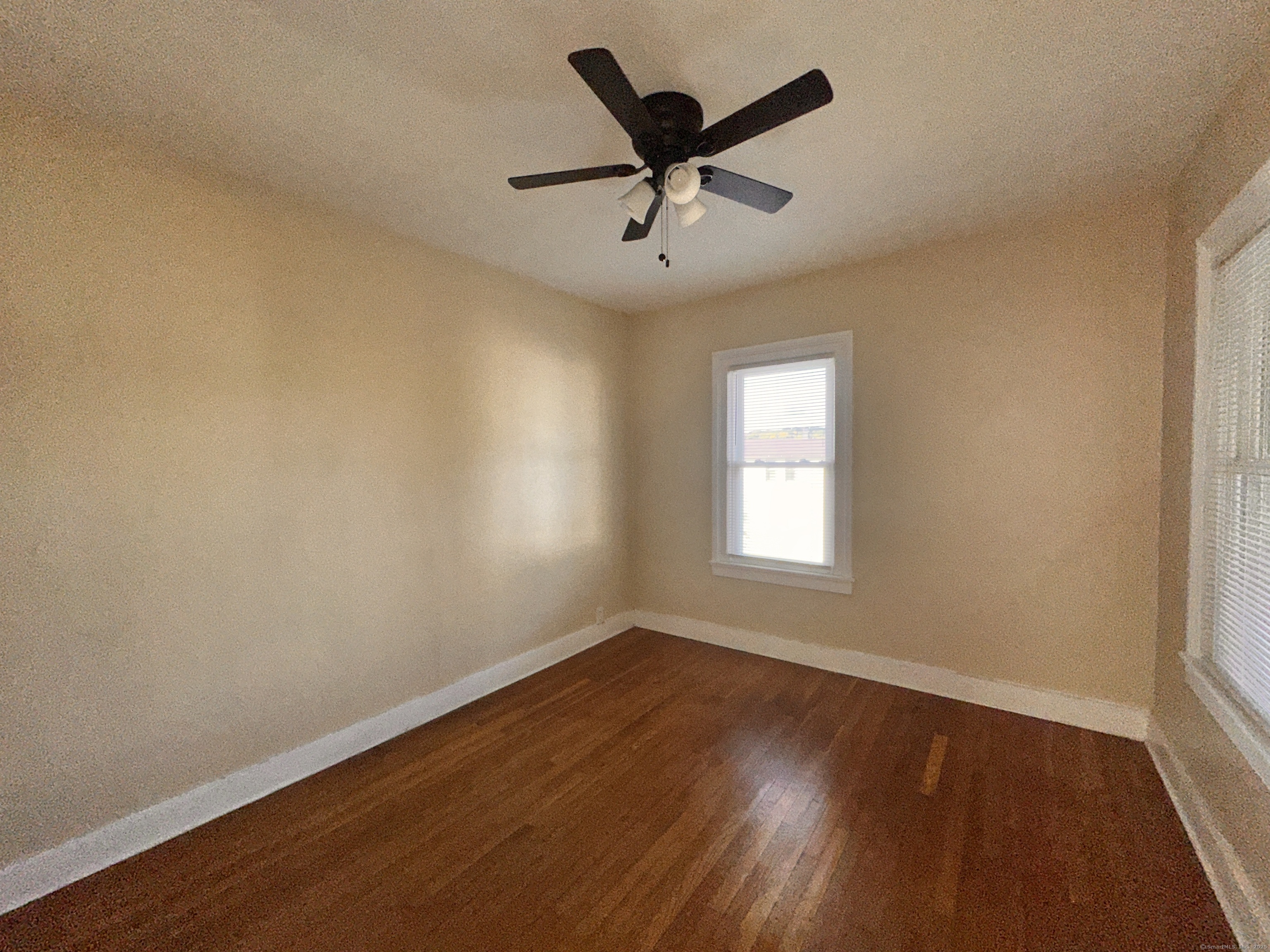 34 North Spring Street Ansonia, CT 06401 - Photo 11 of 20 a view of a big room with wooden floor and windows