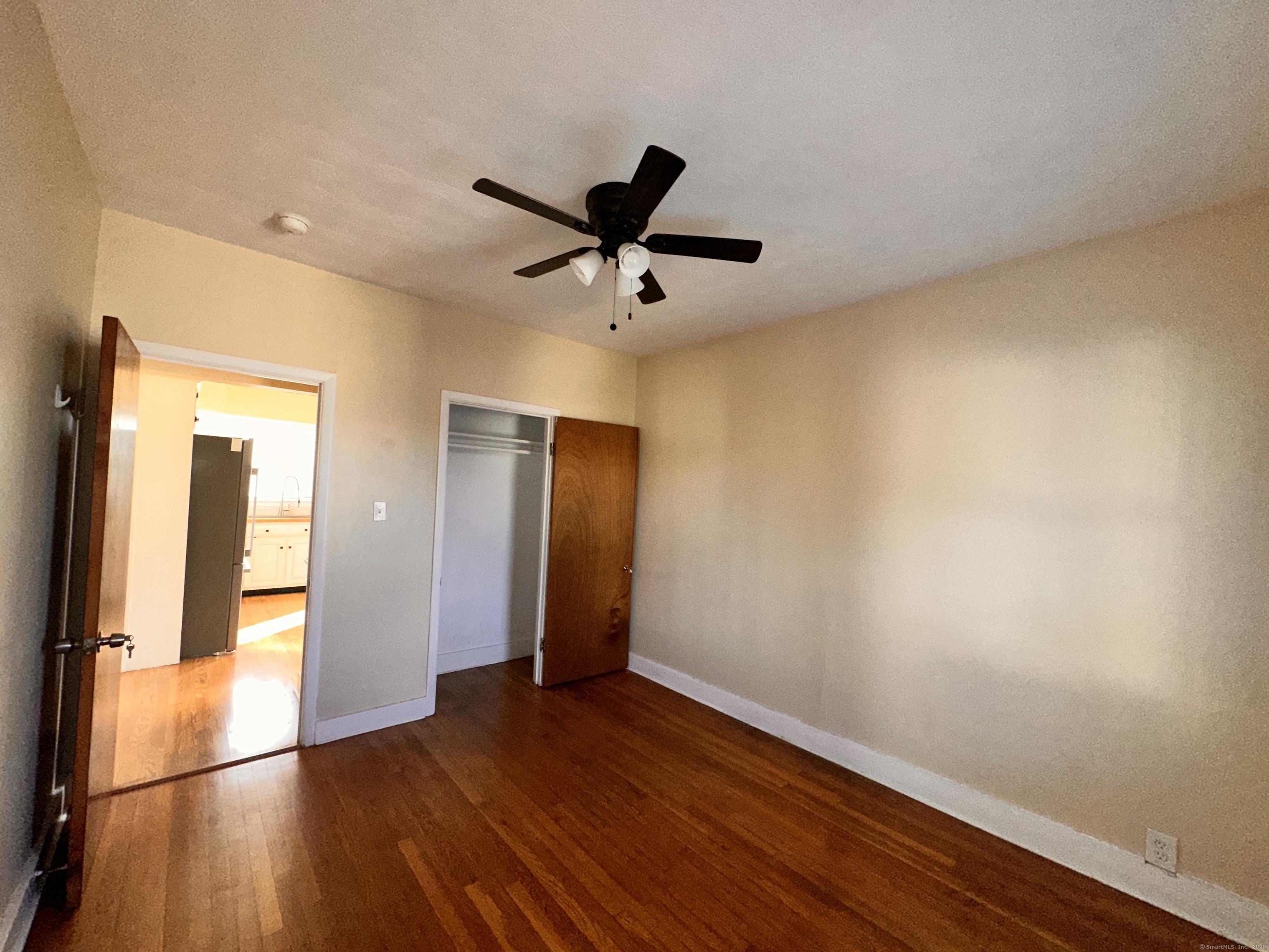 34 North Spring Street Ansonia, CT 06401 - Photo 12 of 20 a view of a livingroom with wooden floor and a ceiling fan