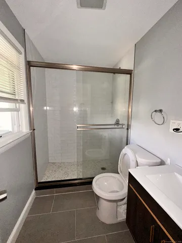 a bathroom with a toilet a sink and a shower