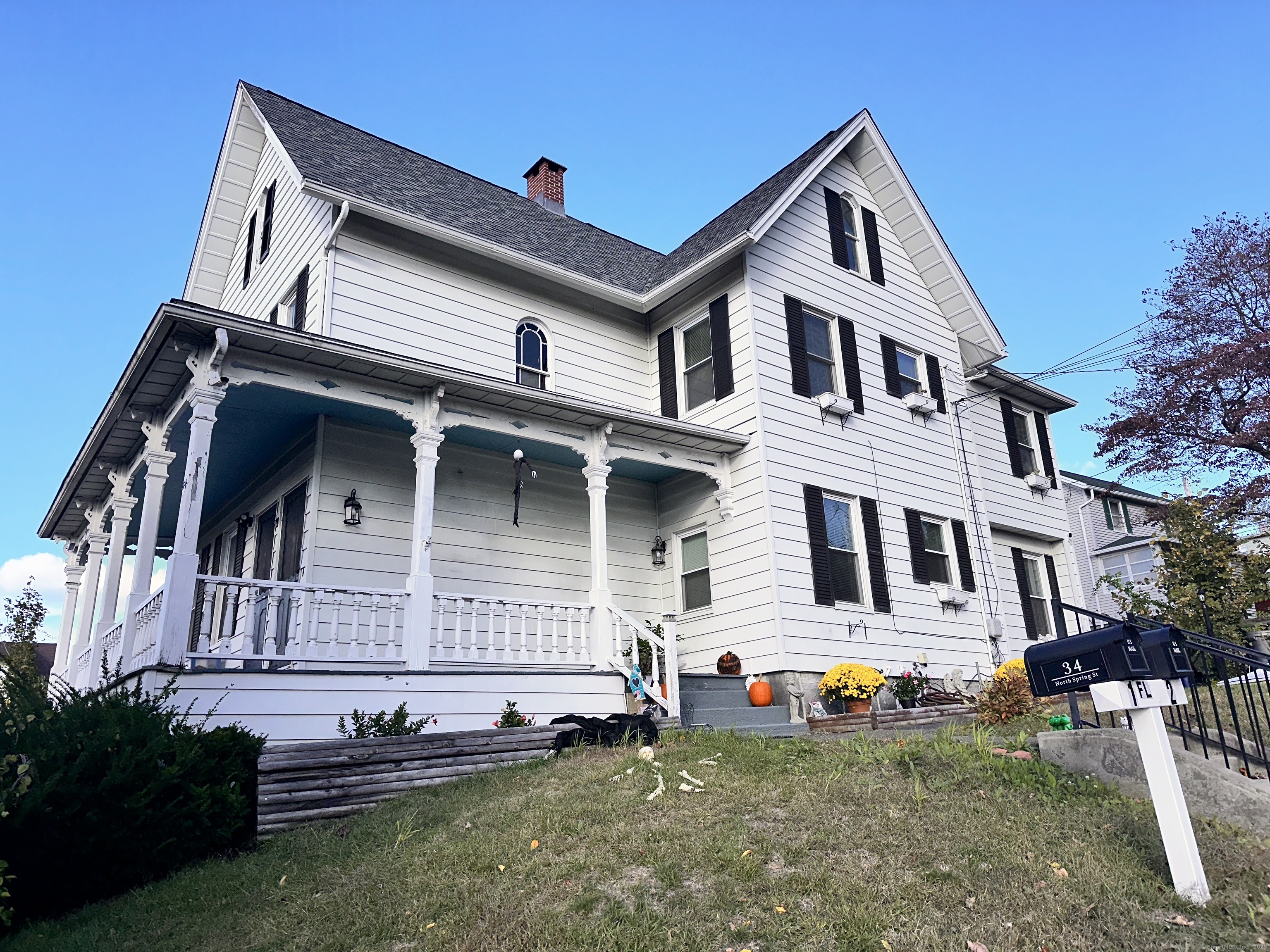 34 North Spring Street Ansonia, CT 06401 - Photo 19 of 20 a view of a white house with large windows and a yard