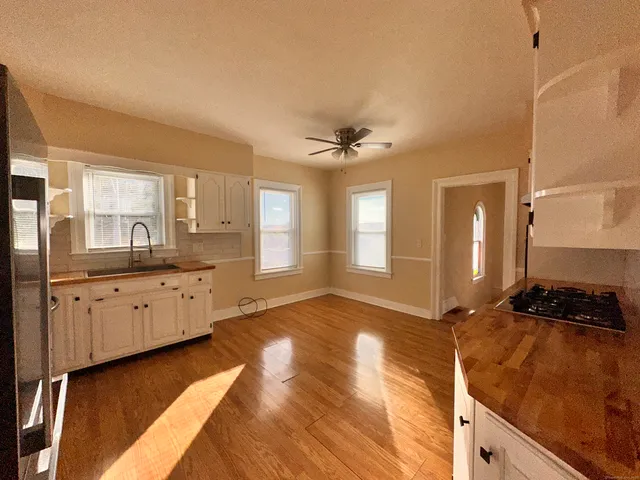 a spacious bathroom with a double vanity sink a mirror and a bathtub