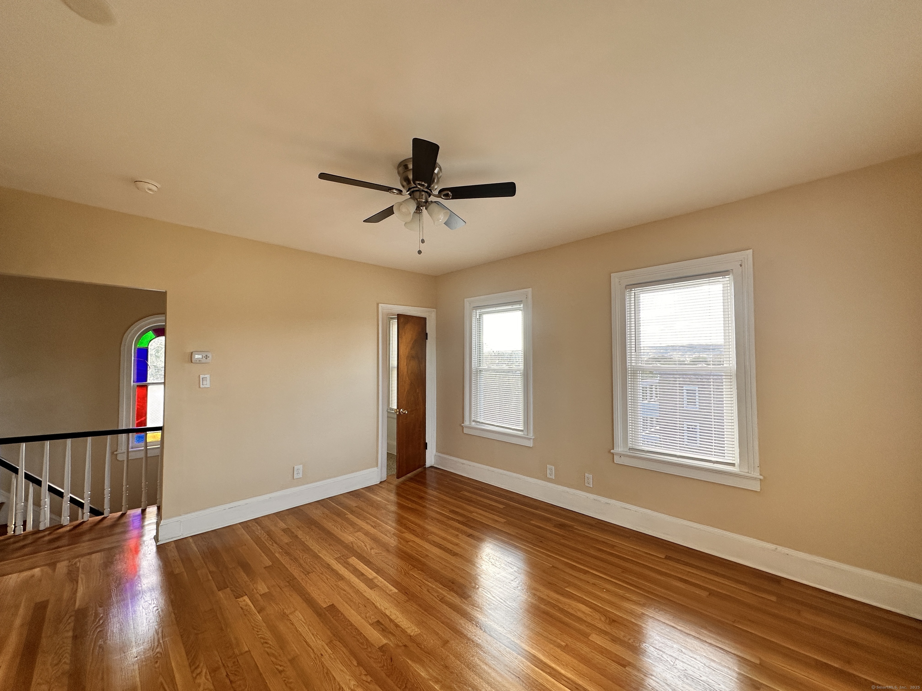 34 North Spring Street Ansonia, CT 06401 - Photo 4 of 20 a view of a livingroom with wooden floor and a ceiling fan