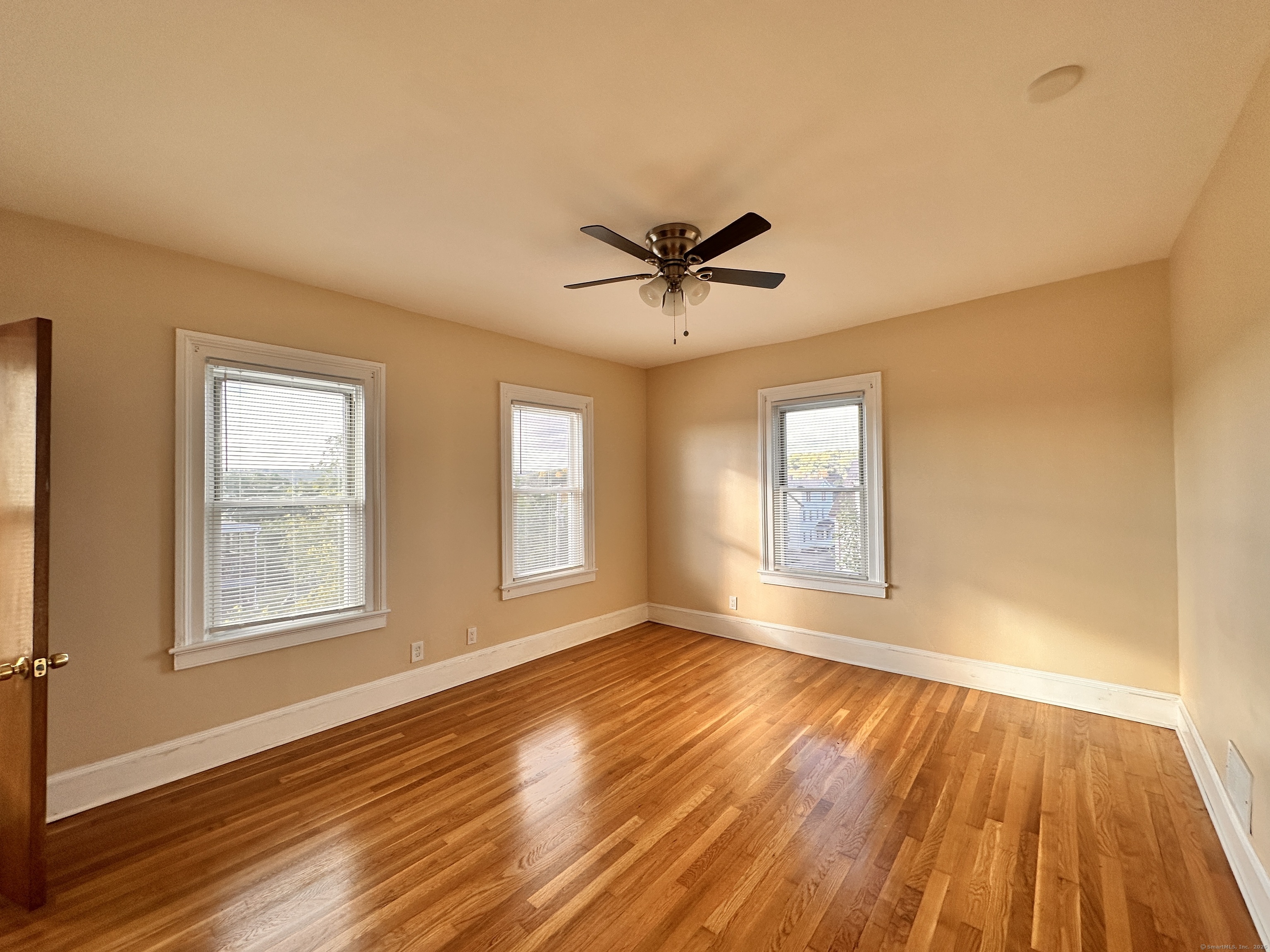 34 North Spring Street Ansonia, CT 06401 - Photo 5 of 20 a view of an empty room with wooden floor and a window