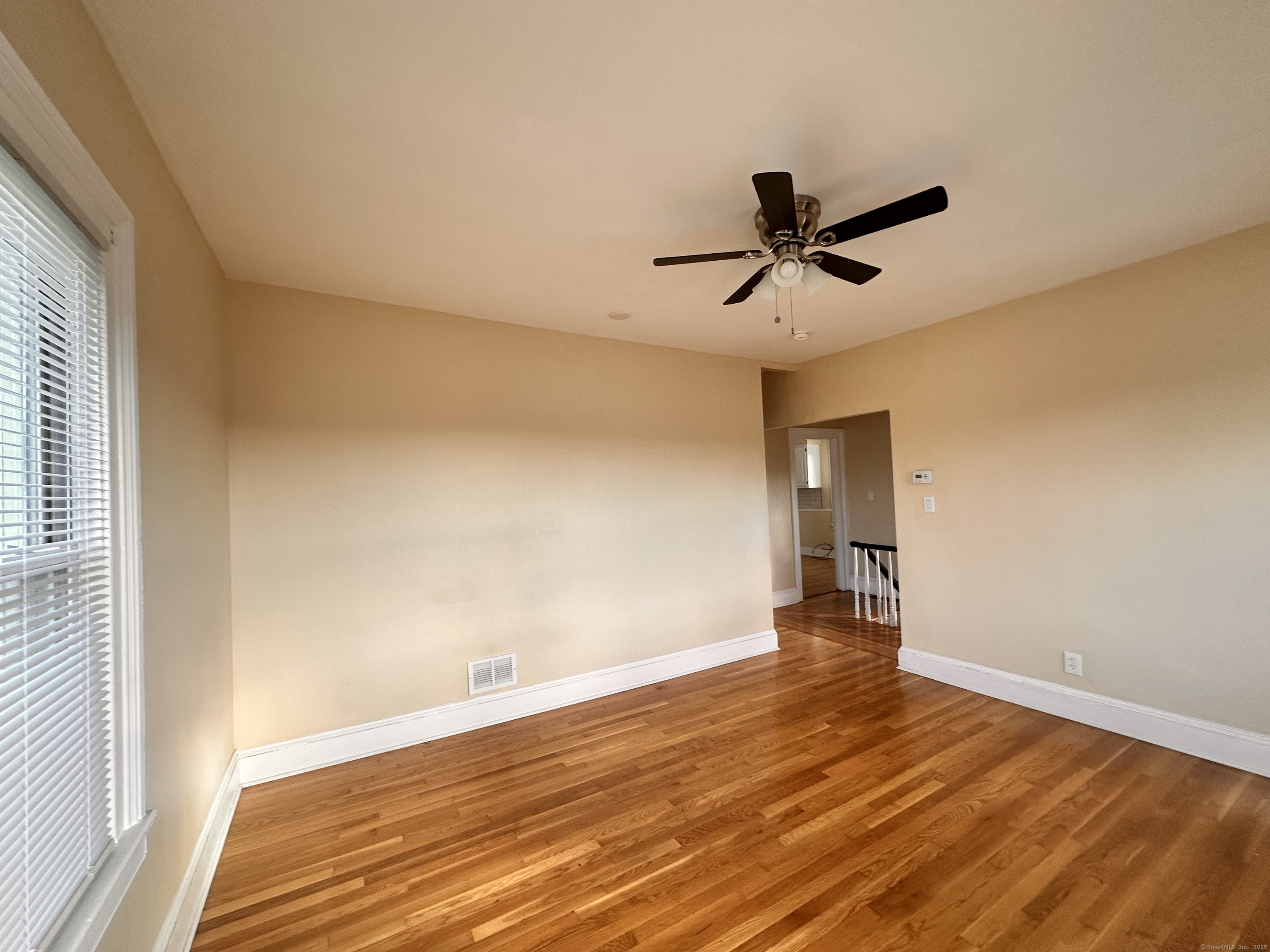 34 North Spring Street Ansonia, CT 06401 - Photo 7 of 20 a view of empty room with wooden floor and fan