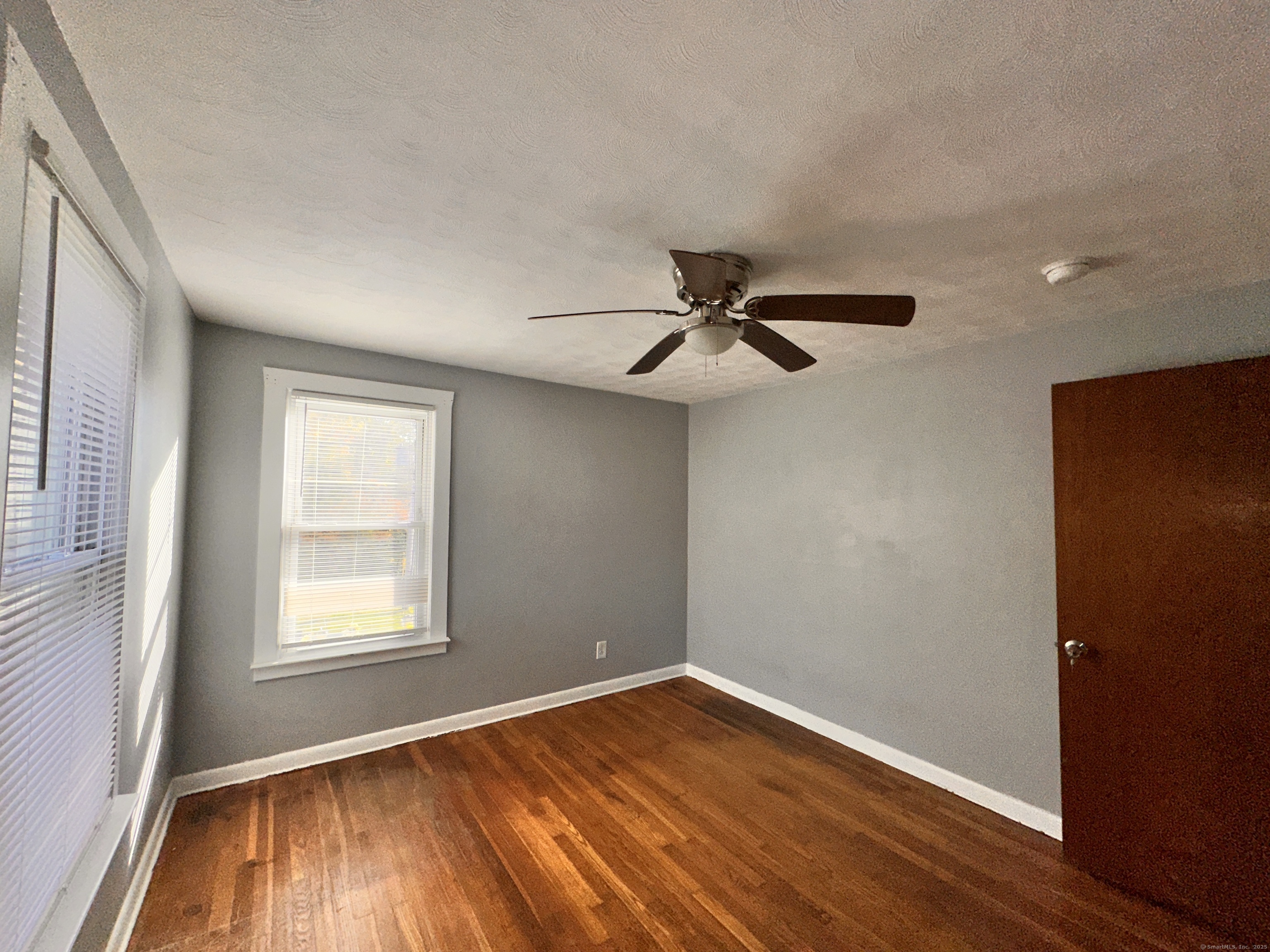 34 North Spring Street Ansonia, CT 06401 - Photo 8 of 20 an empty room with wooden floor fan and windows