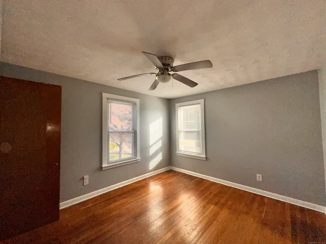 a view of a livingroom with a ceiling fan and window