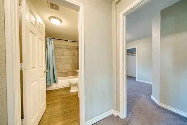 a view of a bathroom from a hallway