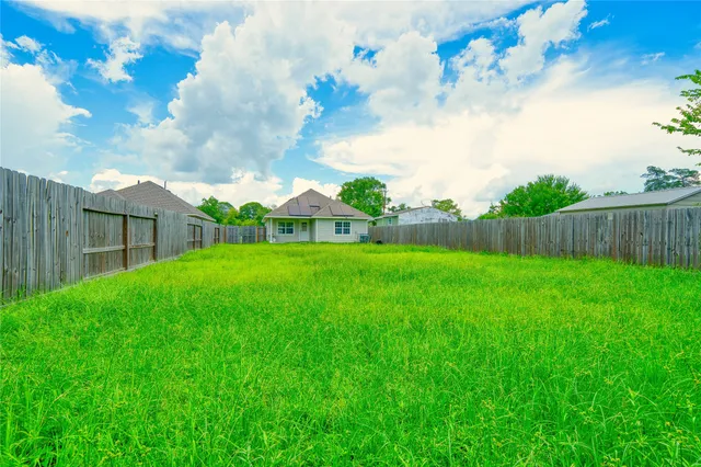 a view of yard with swimming pool and green space