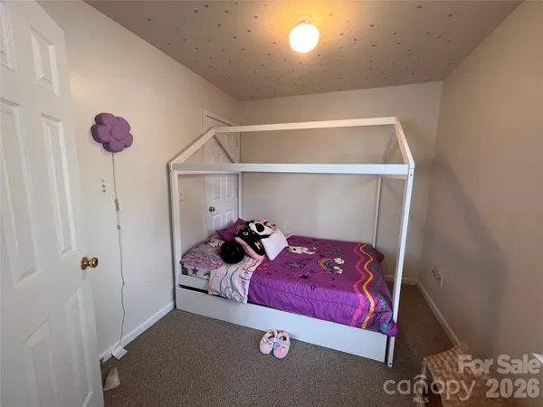 a view of walk in closet with clothes