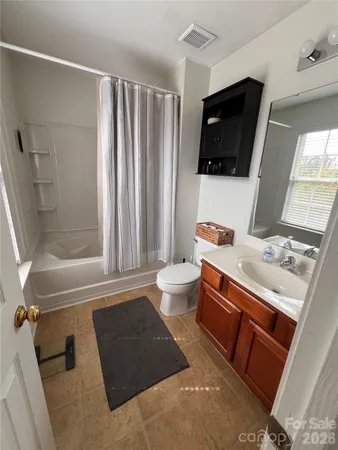 a bathroom with a toilet a sink and a mirror