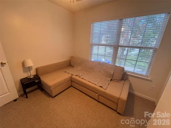 a bed room with furniture and a window