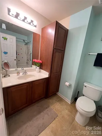 a white toilet sitting next to a bathroom sink