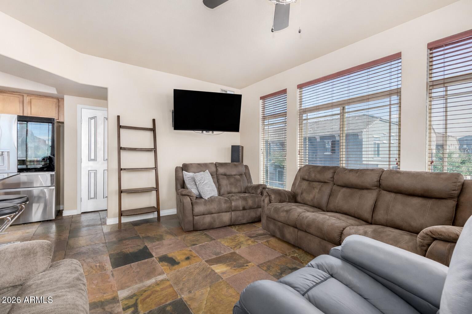 2402 East 5th Street, Unit 1590 Tempe, AZ 85288 - Photo 13 of 33 a living room with furniture and a flat screen tv