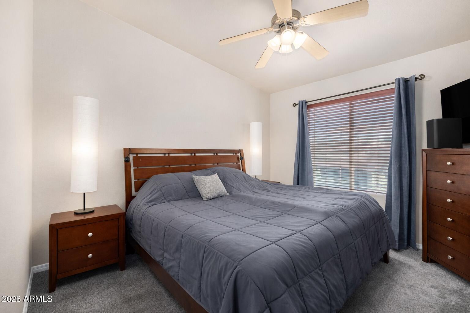2402 East 5th Street, Unit 1590 Tempe, AZ 85288 - Photo 16 of 33 a bedroom with a bed and a flat tv screen on dresser