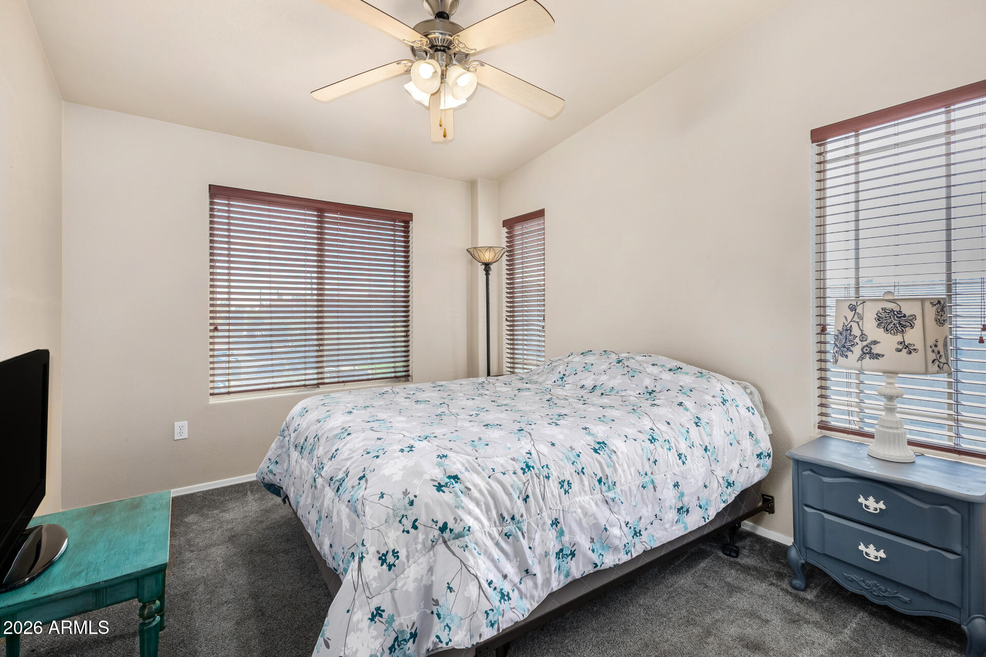 2402 East 5th Street, Unit 1590 Tempe, AZ 85288 - Photo 18 of 33 a bedroom with a bed and a flat tv screen on dresser