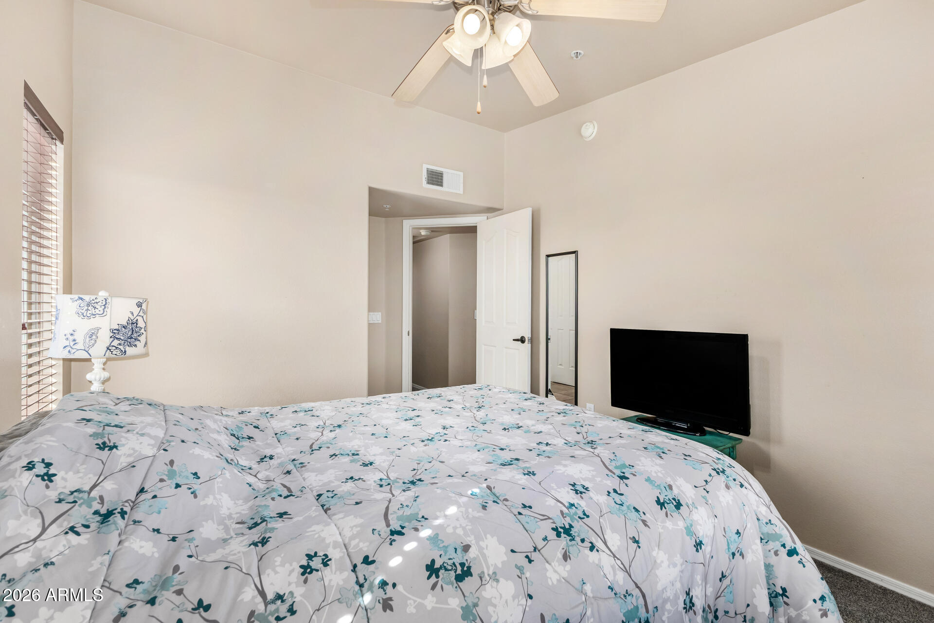 2402 East 5th Street, Unit 1590 Tempe, AZ 85288 - Photo 19 of 33 a bedroom with a bed and a flat screen tv