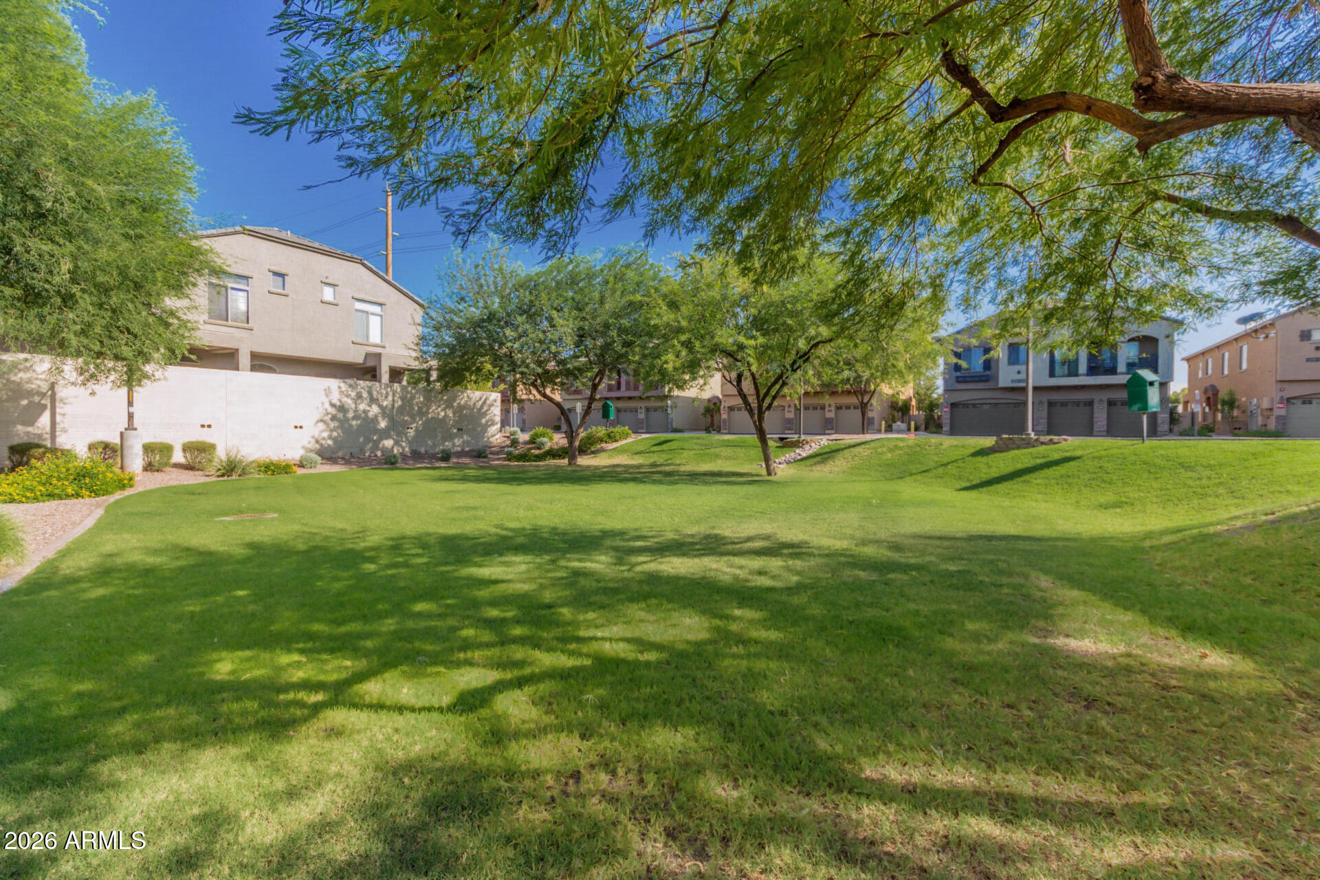 2402 East 5th Street, Unit 1590 Tempe, AZ 85288 - Photo 32 of 33 a view of a tree in front of a house