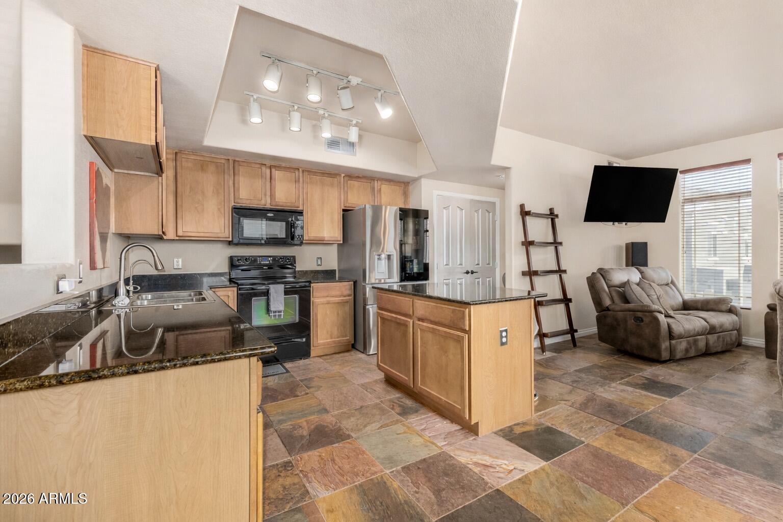 2402 East 5th Street, Unit 1590 Tempe, AZ 85288 - Photo 7 of 33 a large kitchen with stainless steel appliances a stove a sink a microwave and a refrigerator