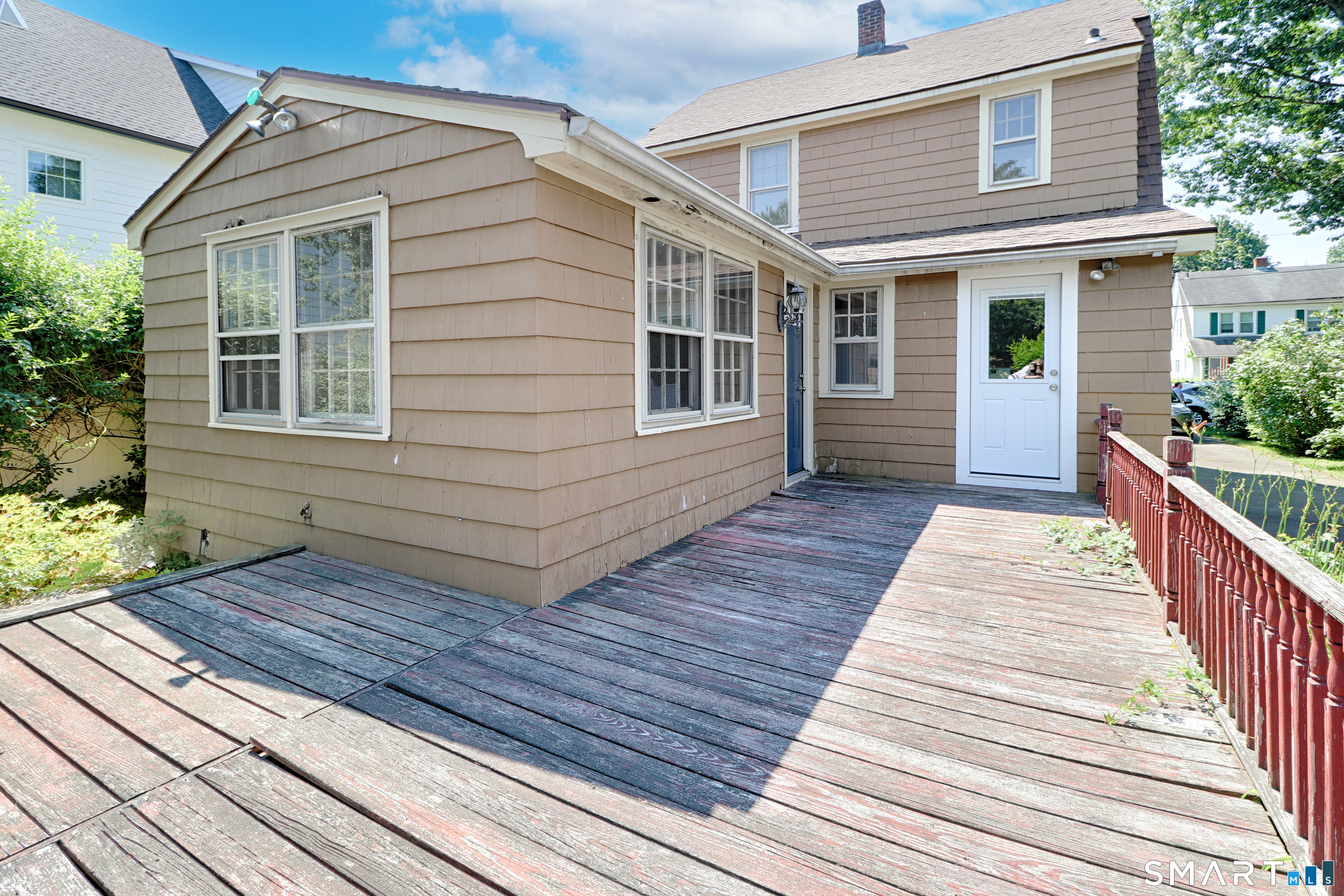 104 Henderson Road Fairfield, CT 06824 - Photo 22 of 26 Large backyard deck with access from the kitchen and family room.