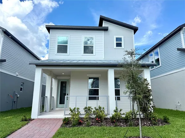 a front view of a house with a yard garage and outdoor seating