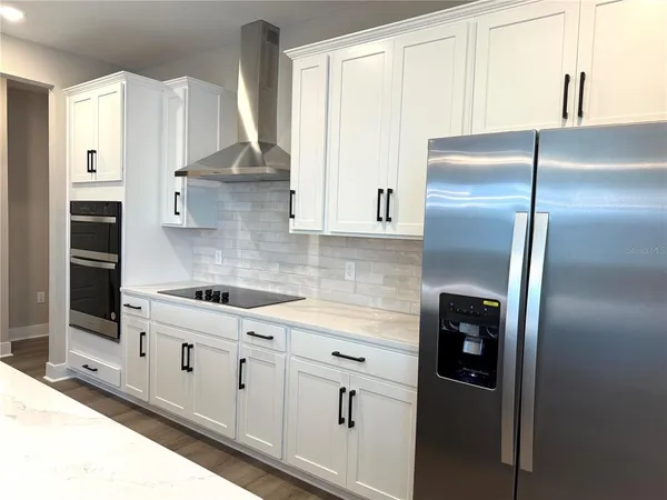 a kitchen with cabinets and stainless steel appliances